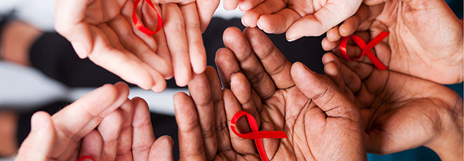 Lots of hands holding red ribbons. © Michael Jung/Fotolia